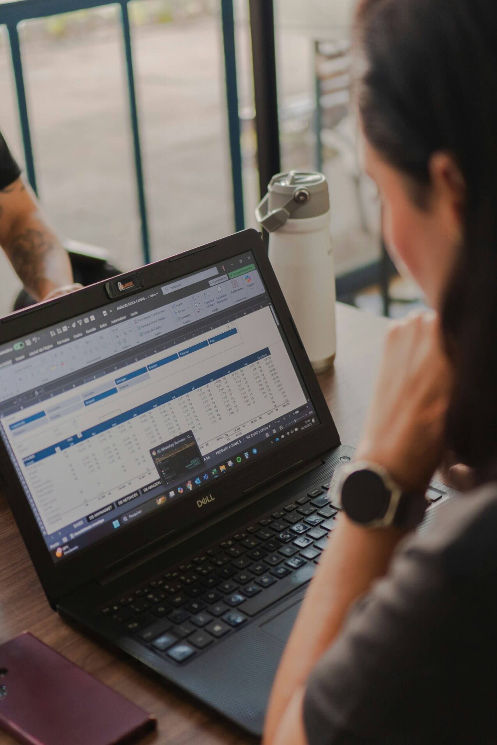 Person working on a laptop spreadsheet