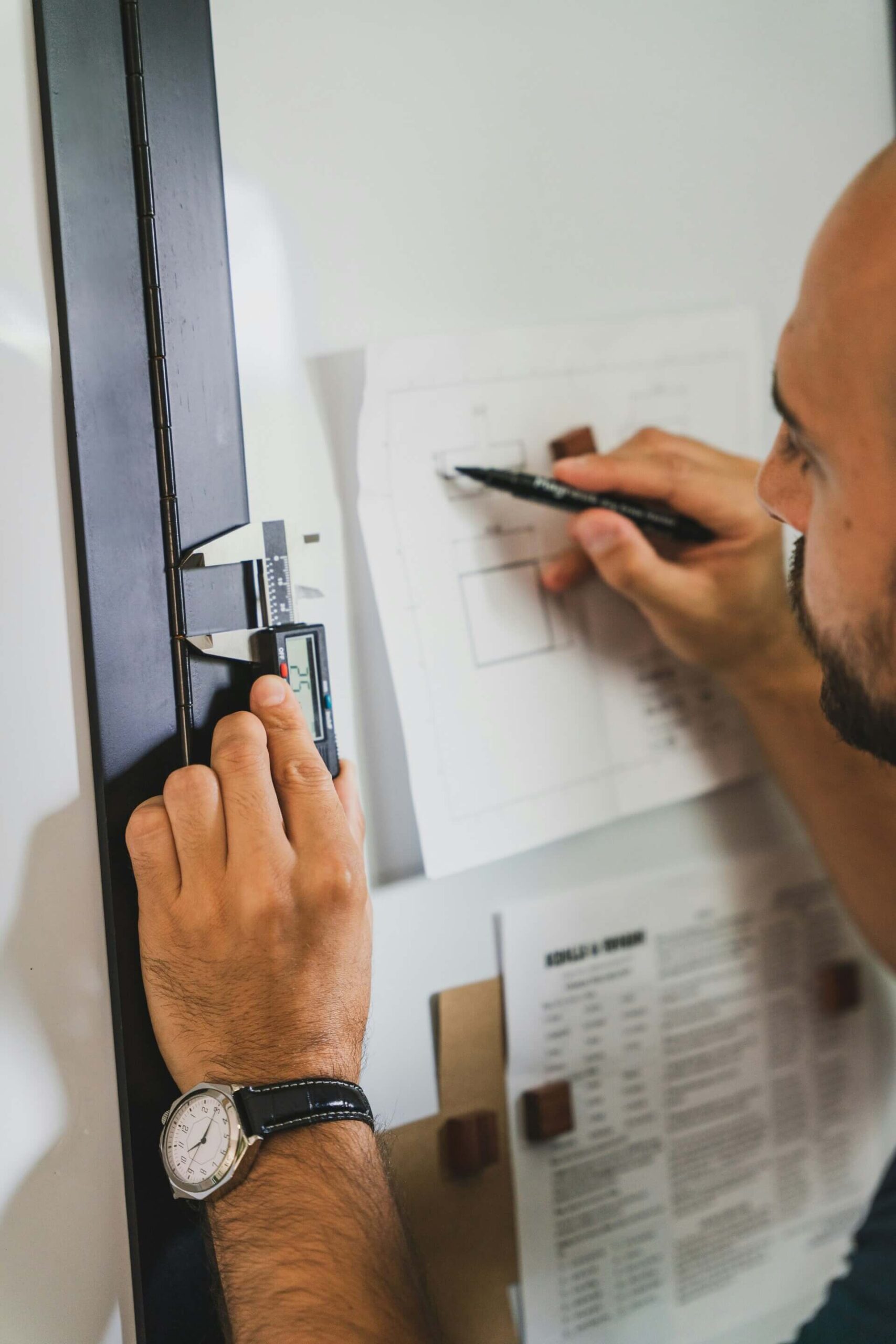 Person measuring and sketching plans