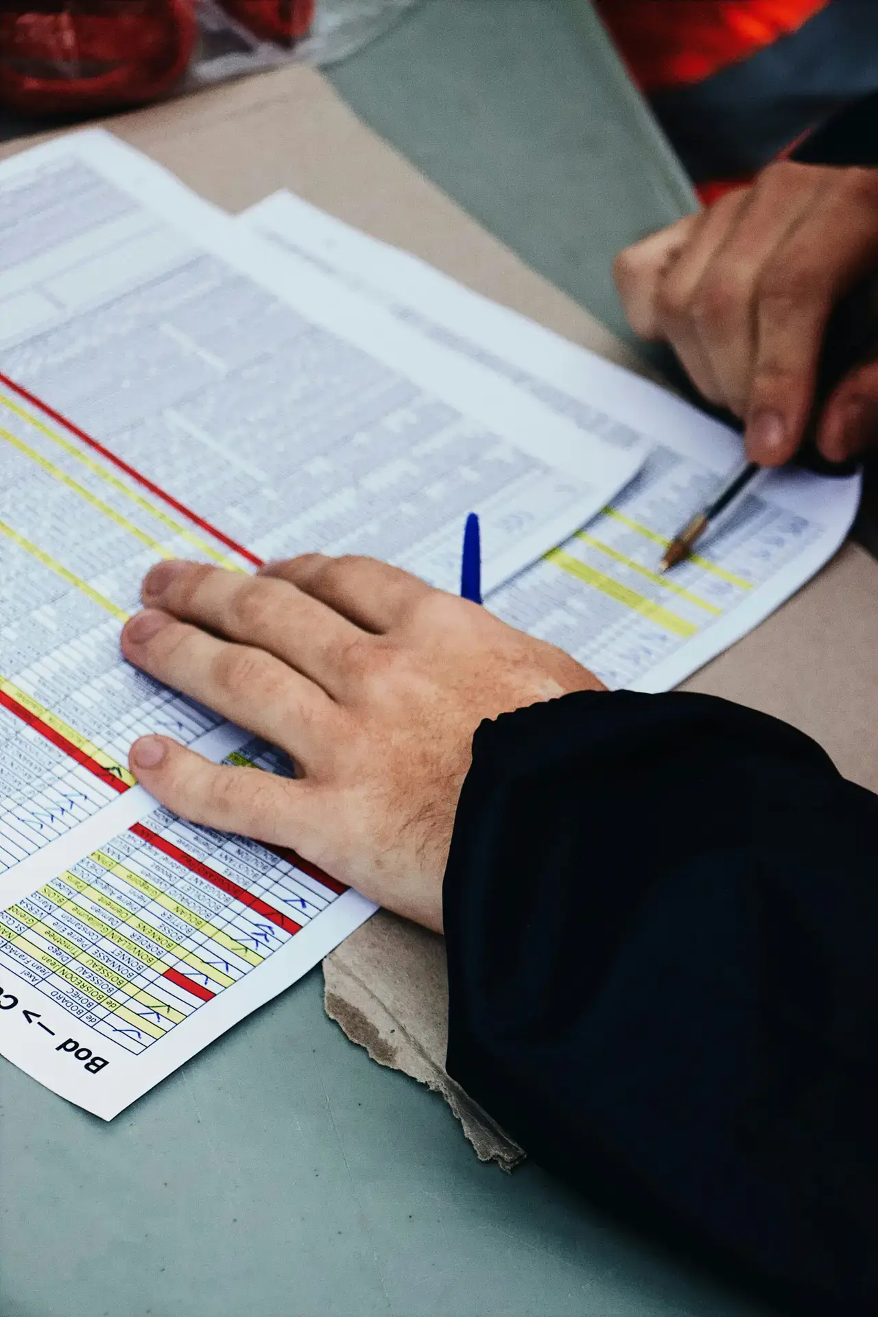 Hands reviewing documents with pen