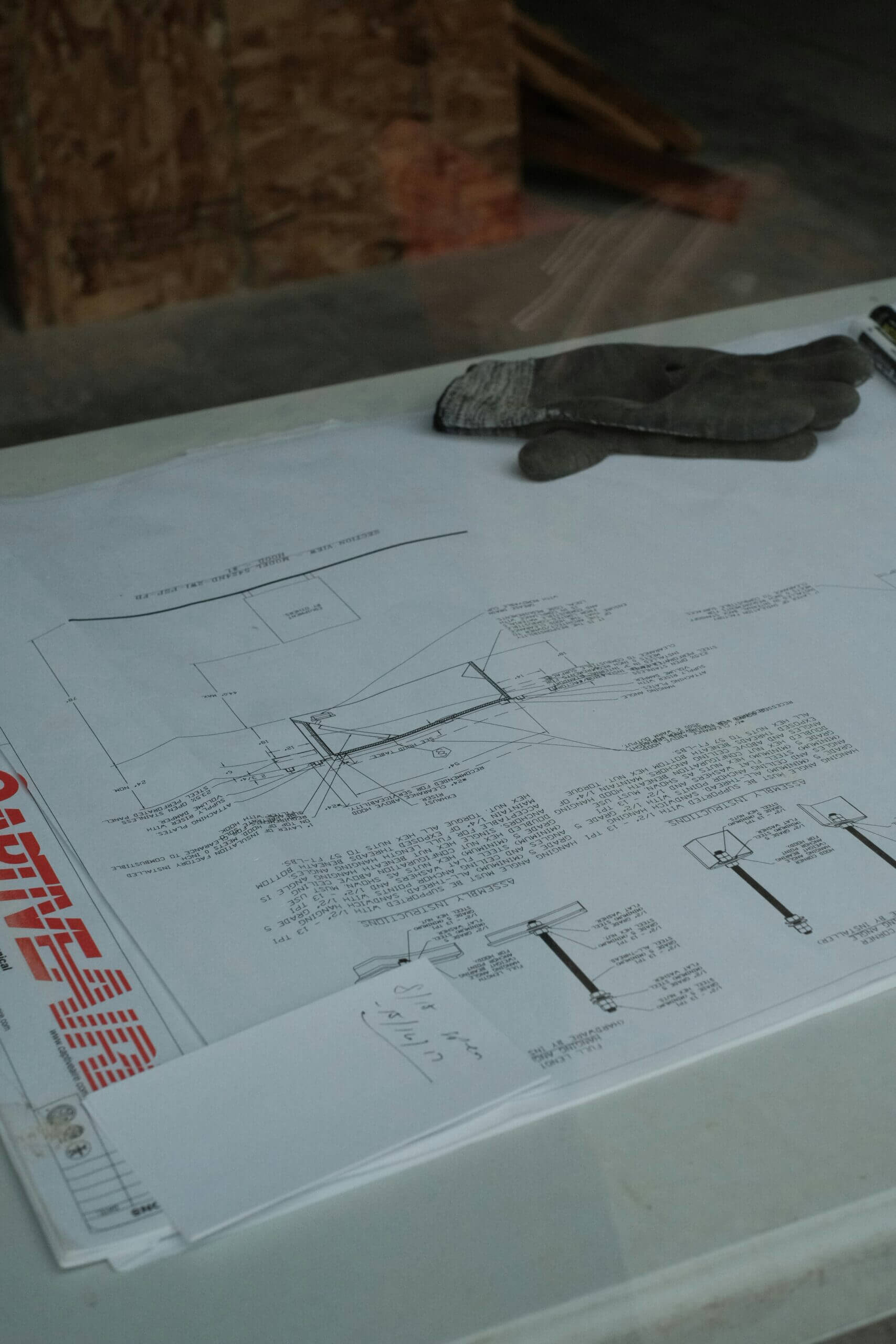 Blueprints and gloves on a table