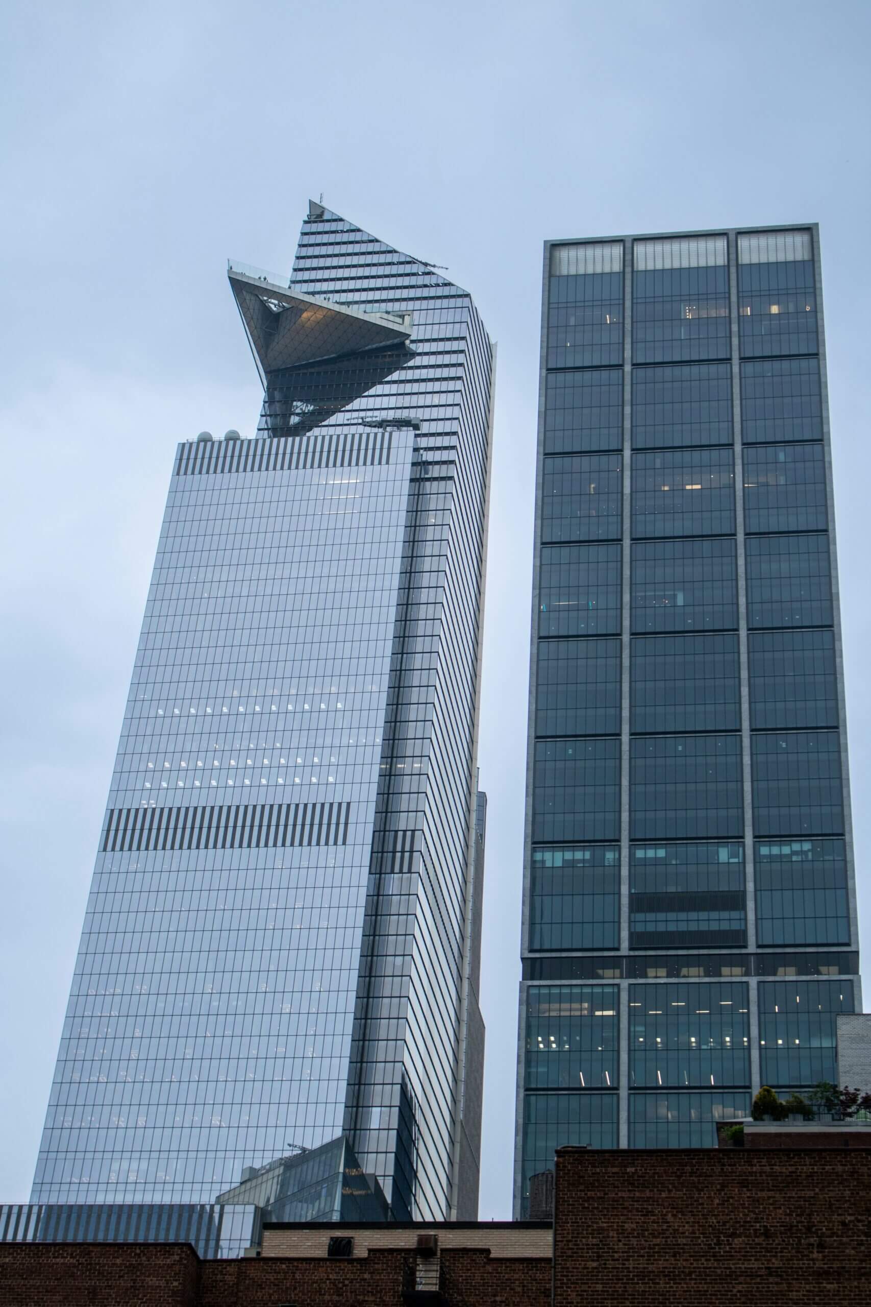 Two modern skyscrapers with glass facades.